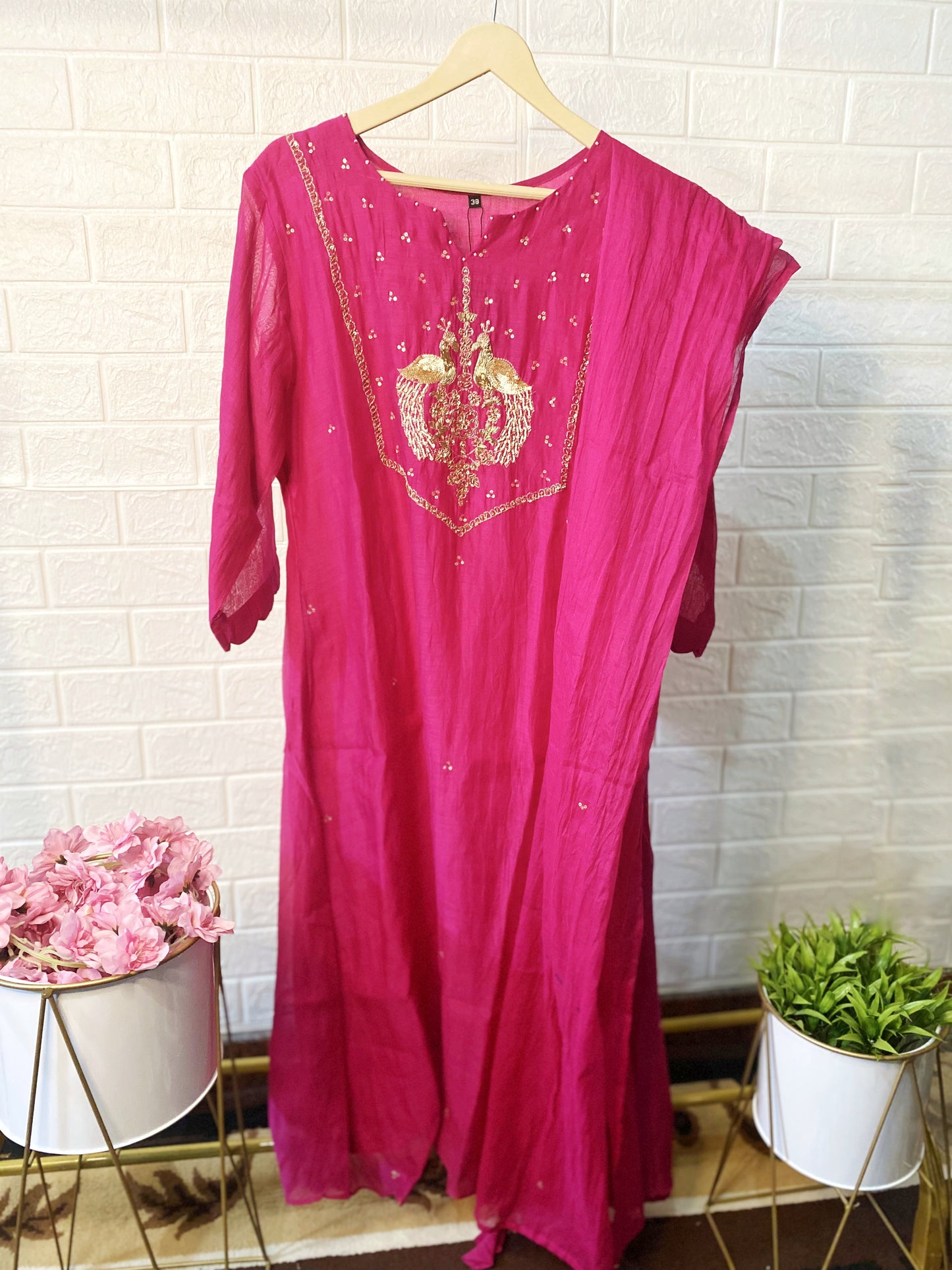 Elegant pink Mul Chanderi kurta with gold peacock embroidery.